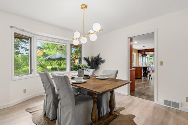 6521 Gleason Rd, Edina, MN 55439 - dining space featuring plenty of natural light, a chandelier, and wood finished floors