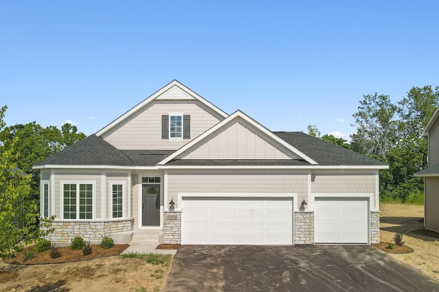 10633 29th St NE, Saint Michael, MN 55376 - craftsman inspired home featuring stone siding, asphalt driveway, an attached garage, and a shingled roof
