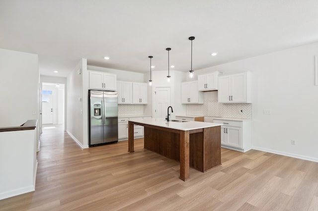 10633 29th St NE, Saint Michael, MN 55376 - kitchen featuring stainless steel refrigerator with ice dispenser, a sink, backsplash, light wood-style flooring, and recessed lighting