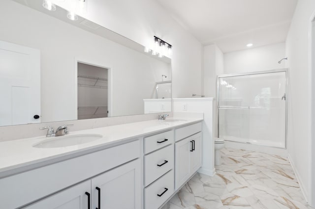 10633 29th St NE, Saint Michael, MN 55376 - bathroom featuring toilet, double vanity, a shower stall, marble look tile flooring, and recessed lighting