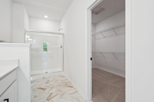 10633 29th St NE, Saint Michael, MN 55376 - bathroom with a stall shower, vanity, toilet, a walk in closet, and marble finish floors
