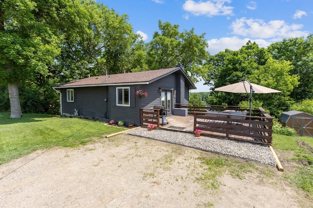 4616 Fillmore Ave NW, Maple Lake Twp, MN 55358 - back of property featuring a deck, a yard, and view of scattered trees