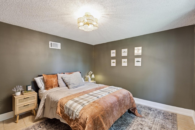 4616 Fillmore Ave NW, Maple Lake Twp, MN 55358 - bedroom featuring light tile patterned flooring, a chandelier, a textured ceiling, and baseboards