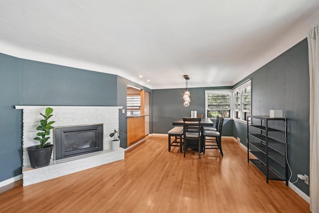 1346 Como Ave, Saint Paul, MN 55108 - dining room featuring wood finished floors, plenty of natural light, a brick fireplace, and recessed lighting