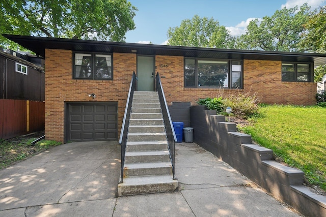 1346 Como Ave, Saint Paul, MN 55108 - view of front facade with brick siding, driveway, and an attached garage