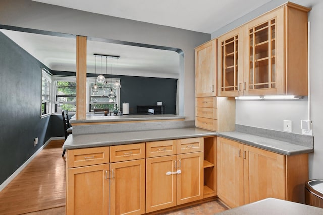 1346 Como Ave, Saint Paul, MN 55108 - kitchen featuring glass insert cabinets, light wood-type flooring, pendant lighting, a peninsula, and light brown cabinets
