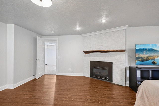 1346 Como Ave, Saint Paul, MN 55108 - living area featuring wood finished floors, a fireplace, and a textured ceiling