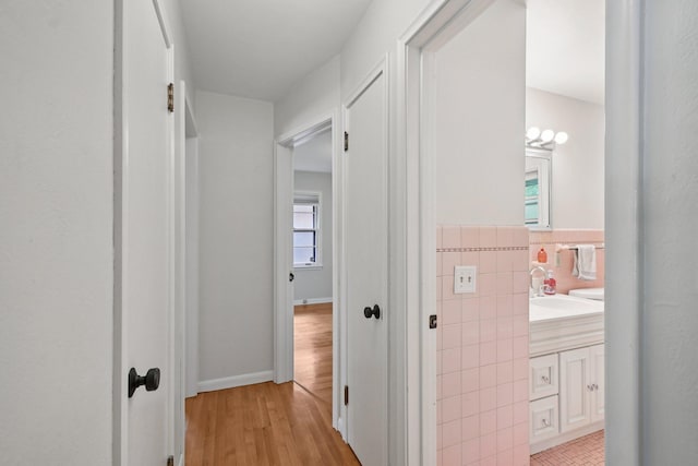 1346 Como Ave, Saint Paul, MN 55108 - corridor featuring tile walls and light wood-type flooring