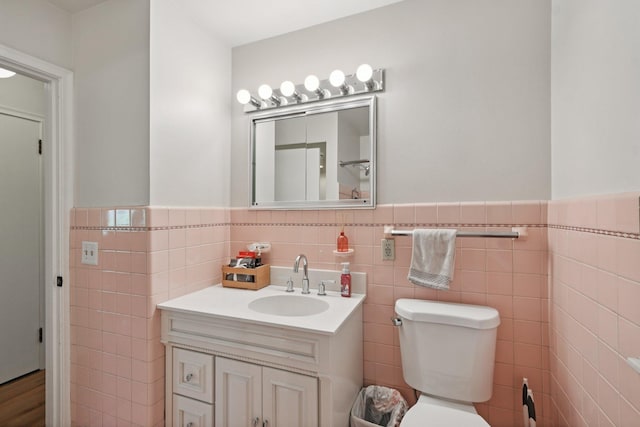 1346 Como Ave, Saint Paul, MN 55108 - bathroom with tile walls, vanity, and a wainscoted wall