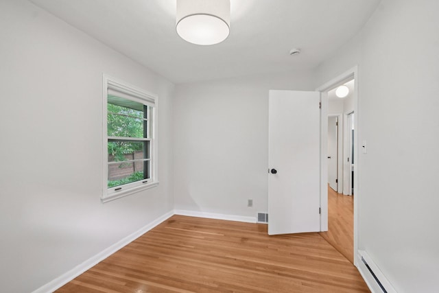 1346 Como Ave, Saint Paul, MN 55108 - empty room with light wood-style floors, a baseboard radiator, and a smoke detector