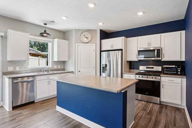 11505 Pineridge Way N, Dayton, MN 55327 - kitchen featuring stainless steel appliances, wood finished floors, light countertops, white cabinets, and recessed lighting