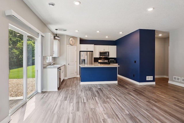 11505 Pineridge Way N, Dayton, MN 55327 - kitchen featuring stainless steel appliances, light wood finished floors, white cabinets, light countertops, and recessed lighting