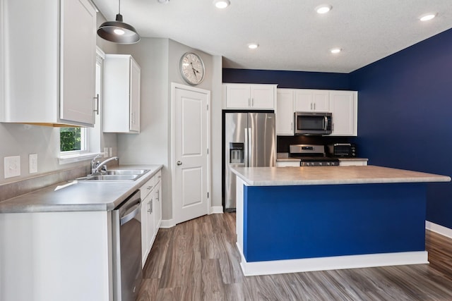 11505 Pineridge Way N, Dayton, MN 55327 - kitchen with stainless steel appliances, white cabinetry, wood finished floors, light countertops, and recessed lighting