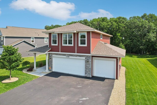 11505 Pineridge Way N, Dayton, MN 55327 - view of front of home featuring asphalt driveway, a shingled roof, a front yard, stone siding, and an attached garage