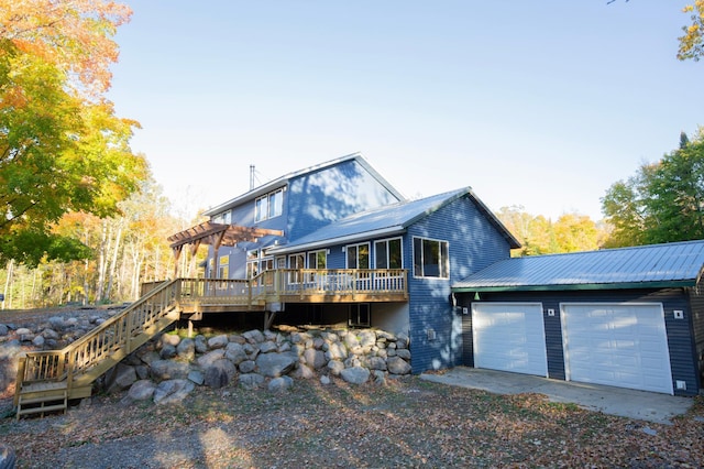 6860 Re Echo Ridge Dr NE, Remer, MN 56672 - view of front of home featuring a pergola, a wooden deck, stairway, and a garage