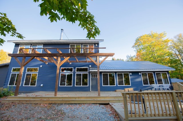 6860 Re Echo Ridge Dr NE, Remer, MN 56672 - rear view of house with a deck, outdoor dining space, and metal roof