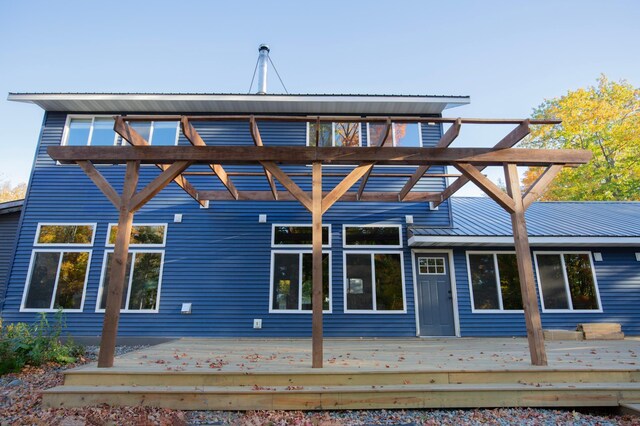 6860 Re Echo Ridge Dr NE, Remer, MN 56672 - rear view of house featuring a wooden deck and metal roof