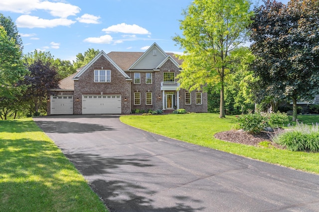 9256 Gateway Ln, Eden Prairie, MN 55347 - view of front of house featuring driveway, brick siding, a front lawn, and an attached garage