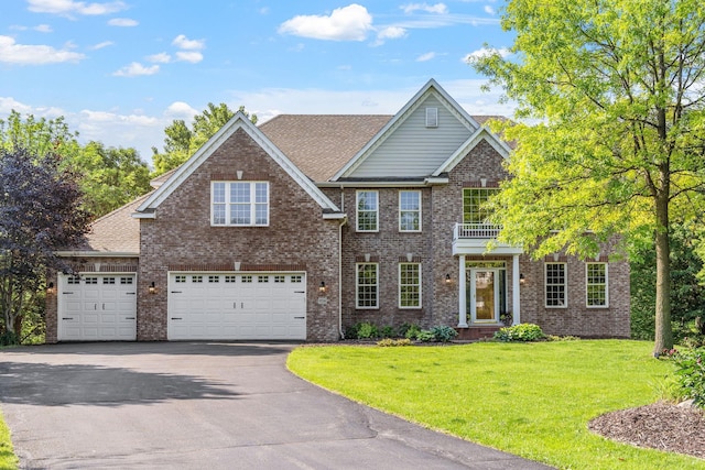 9256 Gateway Ln, Eden Prairie, MN 55347 - colonial-style house with driveway, a front lawn, a balcony, and brick siding