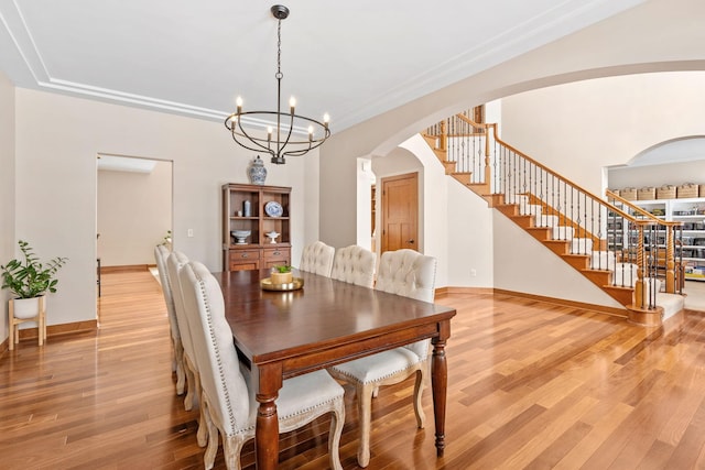 9256 Gateway Ln, Eden Prairie, MN 55347 - dining area featuring arched walkways, stairway, light wood-type flooring, and baseboards