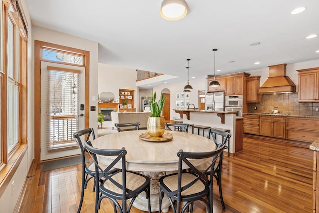 9256 Gateway Ln, Eden Prairie, MN 55347 - dining space with hardwood / wood-style flooring, arched walkways, and recessed lighting