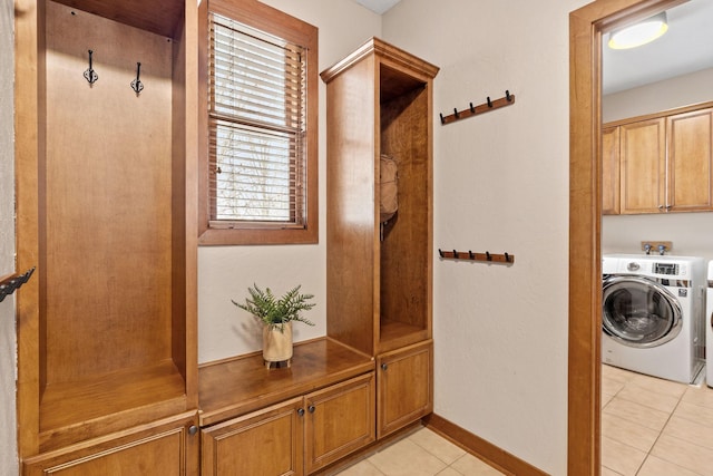 9256 Gateway Ln, Eden Prairie, MN 55347 - mudroom with light tile patterned flooring, baseboards, and washing machine and clothes dryer