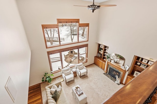 9256 Gateway Ln, Eden Prairie, MN 55347 - living room with a towering ceiling, ceiling fan, healthy amount of natural light, a fireplace with flush hearth, and baseboards