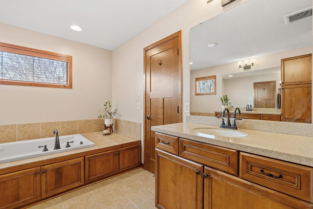 9256 Gateway Ln, Eden Prairie, MN 55347 - bathroom featuring a bath, vanity, tile patterned flooring, and recessed lighting