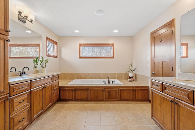 9256 Gateway Ln, Eden Prairie, MN 55347 - bathroom with two vanities, a garden tub, tile patterned flooring, and recessed lighting