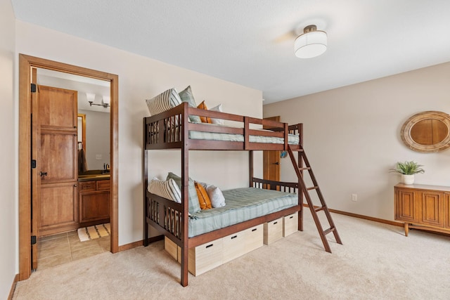 9256 Gateway Ln, Eden Prairie, MN 55347 - bedroom featuring light colored carpet, baseboards, a sink, and ensuite bath