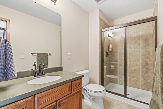 9256 Gateway Ln, Eden Prairie, MN 55347 - bathroom featuring toilet, a stall shower, tile patterned floors, and vanity