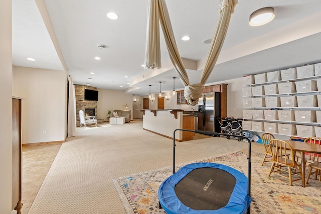 9256 Gateway Ln, Eden Prairie, MN 55347 - playroom featuring light colored carpet, a fireplace, recessed lighting, and baseboards