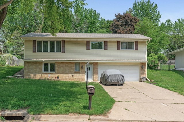 1989 Park Dr, Saint Paul, MN 55119 - view of front of home with driveway, a garage, and brick siding