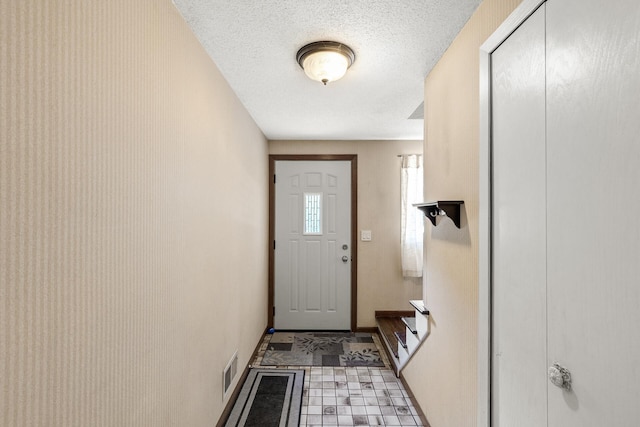 1989 Park Dr, Saint Paul, MN 55119 - doorway to outside featuring a textured ceiling and stairway