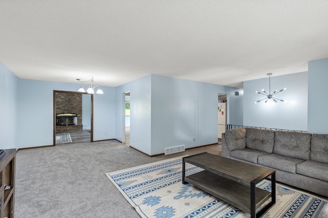 1989 Park Dr, Saint Paul, MN 55119 - living room with a chandelier, a textured ceiling, carpet flooring, and a fireplace