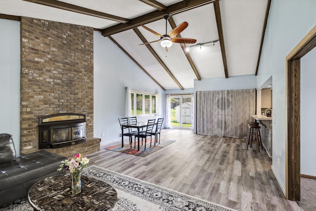 1989 Park Dr, Saint Paul, MN 55119 - living room featuring wood finished floors, beam ceiling, high vaulted ceiling, ceiling fan, and a textured ceiling