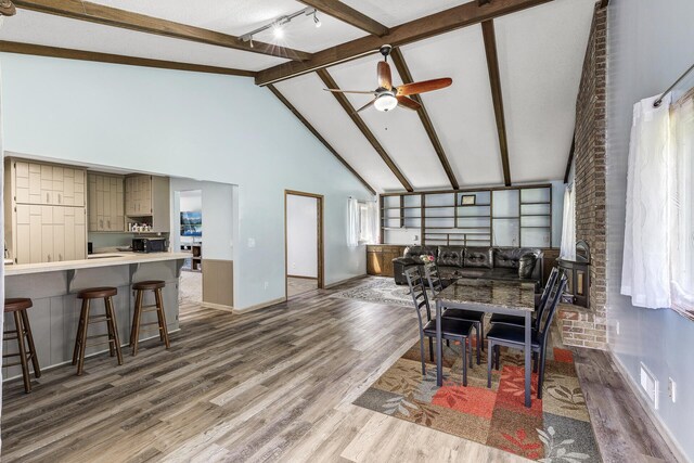 1989 Park Dr, Saint Paul, MN 55119 - dining area with wood finished floors, rail lighting, beam ceiling, ceiling fan, and healthy amount of natural light