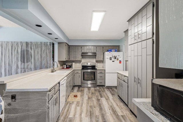 1989 Park Dr, Saint Paul, MN 55119 - kitchen featuring white appliances, gray cabinets, under cabinet range hood, light wood-type flooring, and light countertops