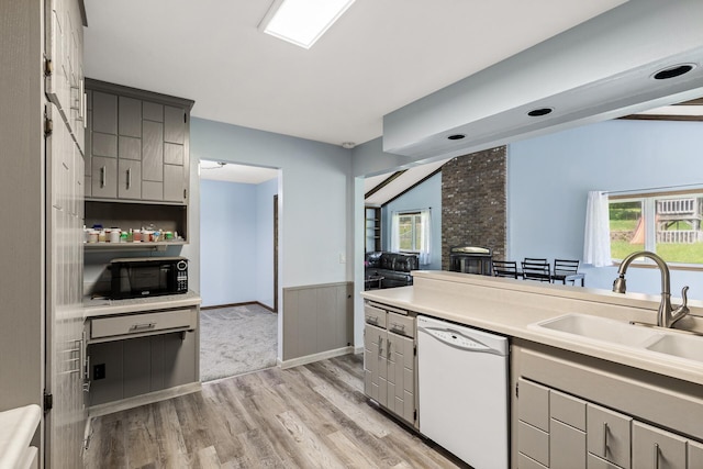 1989 Park Dr, Saint Paul, MN 55119 - kitchen with white dishwasher, gray cabinets, black microwave, light wood-type flooring, and a wainscoted wall