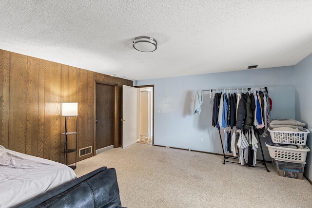 1989 Park Dr, Saint Paul, MN 55119 - carpeted bedroom featuring wood walls and a textured ceiling