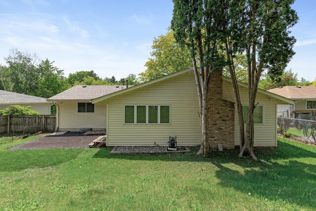 1989 Park Dr, Saint Paul, MN 55119 - back of house with a patio and a chimney