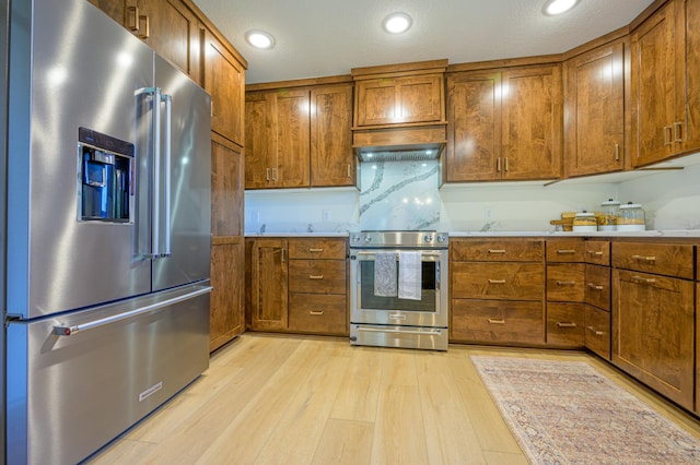 21400 654th Ave, Darwin, MN 55324 - kitchen with stainless steel appliances, brown cabinetry, light wood-style floors, and recessed lighting