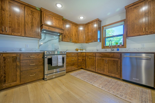 21400 654th Ave, Darwin, MN 55324 - kitchen featuring stainless steel appliances, light wood-style floors, light countertops, brown cabinetry, and recessed lighting