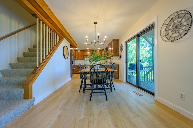 21400 654th Ave, Darwin, MN 55324 - dining room featuring stairs, a chandelier, and light wood-style floors