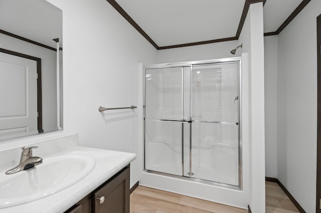 215 Mckay Ave # 59, Alexandria, MN 56308 - full bath with ornamental molding, a stall shower, vanity, and wood finished floors