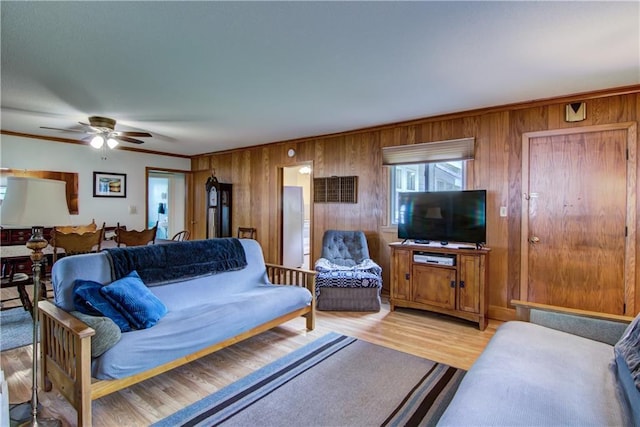 17174 59th Ave, Lafayette Twp, WI 54729 - living room featuring wood walls, ornamental molding, a ceiling fan, and light wood-type flooring