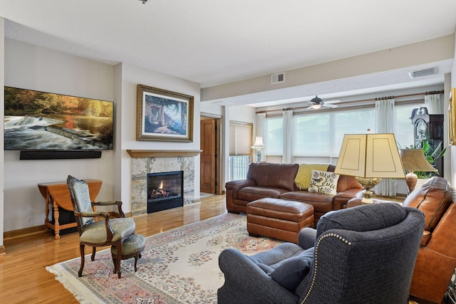2670 Kelley Pkwy Unit 115, Orono, MN 55356 - living area featuring light wood-style floors, a premium fireplace, baseboards, and ceiling fan