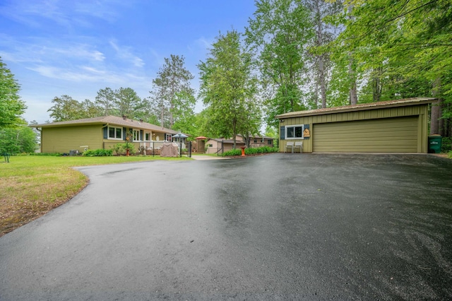 1501 Fraser Dr, Grand Rapids, MN 55744 - view of front of house featuring a detached garage and a front lawn