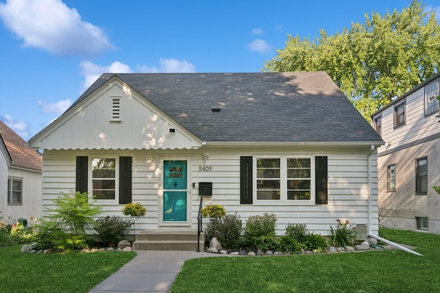 5409 Aldrich Ave S, Minneapolis, MN 55419 - view of front facade featuring a front yard and a shingled roof