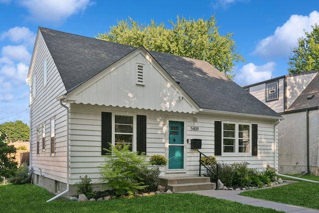 5409 Aldrich Ave S, Minneapolis, MN 55419 - view of front facade featuring a front yard and roof with shingles